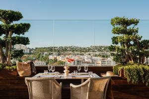 a table and chairs on a balcony with a view at MIM Sitges Member of Melia Collection in Sitges