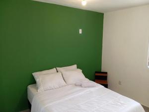 Ένα ή περισσότερα κρεβάτια σε δωμάτιο στο Sana Suítes