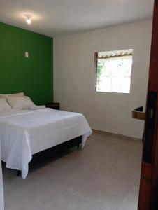 Ένα ή περισσότερα κρεβάτια σε δωμάτιο στο Sana Suítes