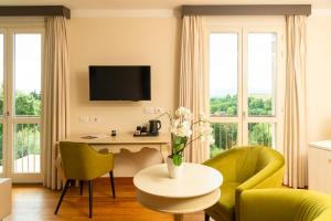 a living room with a table and chairs at Villa Giorgia Albergo in Collina in Pistoia