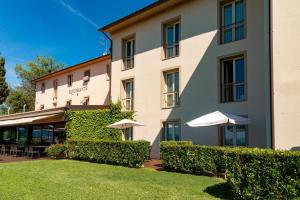 a large building with umbrellas in front of it at Villa Giorgia Albergo in Collina in Pistoia
