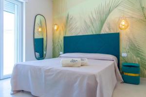 a bedroom with a bed with two towels on it at The Twin Boutique Hotel in Torre Suda