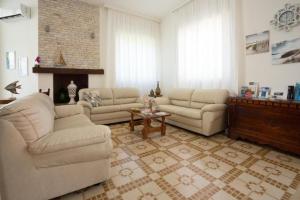 a living room with two couches and a table at The Twin Boutique Hotel in Torre Suda
