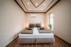 a bedroom with a large bed in a room at White House Apartman Miskolc in Miskolc