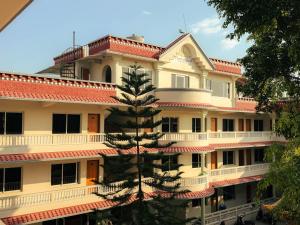a building with a tree in front of it at Tharlam Guest House in Kathmandu