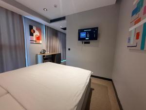 a hospital room with a bed and a flat screen tv at SHERLOCK HOMES HOTELS in Istanbul