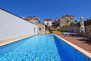 a swimming pool in the backyard of a house at Villa San Rocco with heated pool in Vodnjan