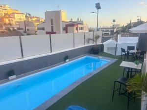 a swimming pool on the roof of a building at Luxe Loma 2 in Mogán