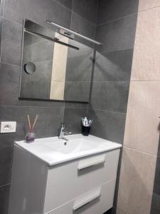 a bathroom with a white sink and a mirror at Luxe Loma 2 in Mogán +4 photos