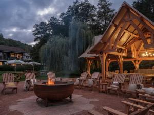 a patio with a fire pit with chairs and a pavilion at The Royal George in Tintern