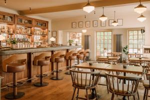 a bar with tables and chairs in a restaurant at The Royal George in Tintern
