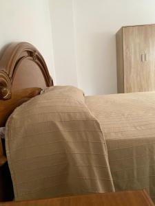 een slaapkamer met een bed en een houten kast bij Casa Roberto in Giulianova