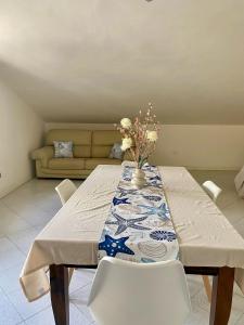 een eetkamer met een tafel met stoelen en een bank bij Casa Roberto in Giulianova +4 foto's