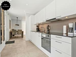 una cucina con armadi bianchi e una sala da pranzo di Ferienhausträume-Bodensee Bergstrassen Apartments a Kreuzlingen