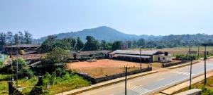 an aerial view of a building next to a road at Annapoorna lodge agumbe in Someshwar +18 photos