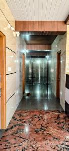 a hallway with a large rug on the floor at Annapoorna lodge agumbe in Someshwar