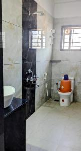 a bathroom with a toilet and a sink at Annapoorna lodge agumbe in Someshwar