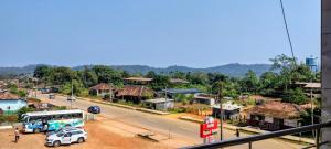 a town with a bus and cars on a street at Annapoorna lodge agumbe in Someshwar