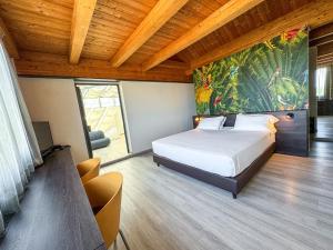 a bedroom with a bed and a painting on the wall at Continental Urban Art Hotel in Zola Predosa +93 photos