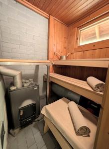 a room with a stove in a wooden cabin at Villa Kelotupa in Hossa