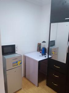 an office with a desk with a computer and a microwave at Short let apartments LBS,Lekki Ajah Lagos in Lekki