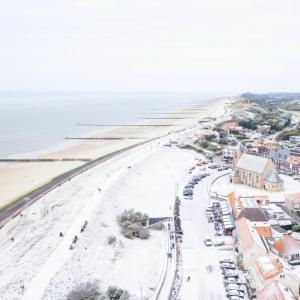 an aerial view of a beach next to the ocean at Stylish Suite Steps To Shore in Zoutelande