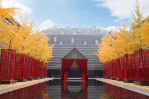 a building with trees in front of a body of water at The Westin Xi'an - Enjoy 2 Free bottles of beer in Xi'an