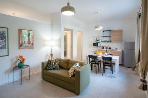 a living room with a couch and a kitchen at MagliaNeraApartment in Quartu Sant'Elena +3 photos