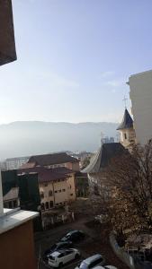 a view of a city with cars parked in a parking lot at Apartament Central in Piatra Neamţ +6 photos