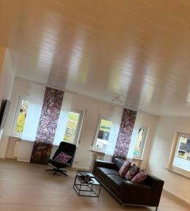 a living room with a couch and some windows at Moselfreunde Ellenz-Poltersdorf in Ellenz-Poltersdorf