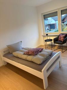 a bed sitting in a room with a window at Moselfreunde Ellenz-Poltersdorf in Ellenz-Poltersdorf