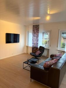 a living room with a couch and two chairs at Moselfreunde Ellenz-Poltersdorf in Ellenz-Poltersdorf +7 photos
