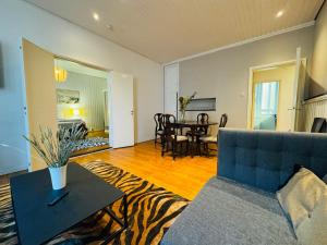 a living room with a couch and a table at STAY Kamppi Center Apartment in Helsinki