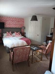 a bedroom with a bed and a table and a chair at Lucker Mill House in Lucker