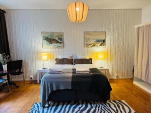 a bedroom with a large bed and two lamps at STAY Kamppi Center Apartment in Helsinki