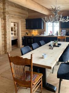 a kitchen with a large wooden table and chairs at Luksuriøs Bjælkehytte Af Hardangervidda in Uvdal