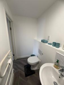 a white bathroom with a toilet and a sink at Modern Studio - Centre Maidstone in Maidstone