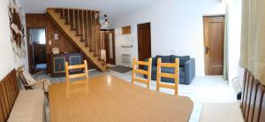 a dining room with a wooden table and chairs at Ferienhaus Spalek in Innerkrems +3 photos