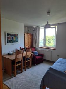 a bedroom with a dining room table and a living room at The John Rand Suite in Samobor