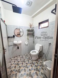 a bathroom with a toilet and a sink at Pan-Ogifan Transient in Baguio