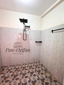a bathroom with a shower with a sign on the wall at Pan-Ogifan Transient in Baguio +8 photos