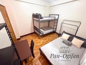 a small room with a bunk bed and a table at Pan-Ogifan Transient in Baguio