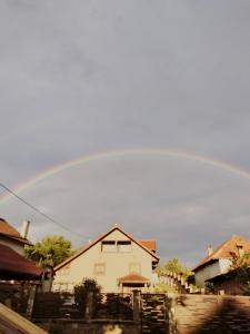 a rainbow in the sky over a house at Darius Room in Novaci