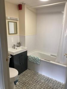 a bathroom with a toilet and a sink and a tub at Brandreth Barn in Burscough +49 photos
