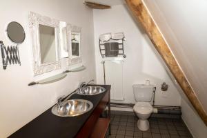 a bathroom with two sinks and a toilet at Maison 1 in Souvigny