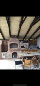 a dining room with a table and a brick fireplace at Darius Room in Novaci
