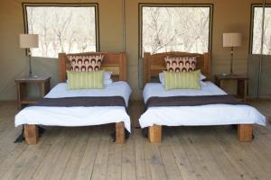 Postel nebo postele na pokoji v ubytování Miombo Safari