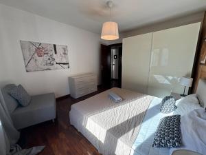 Ένα ή περισσότερα κρεβάτια σε δωμάτιο στο Cadore Flat - il Tuo Rifugio tra le Montagne