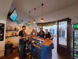 a group of people standing at a bar at Holis in Sucre