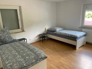 a room with two beds and a window at Eigentumswohnung für 5 Personen in Donzdorf +2 photos